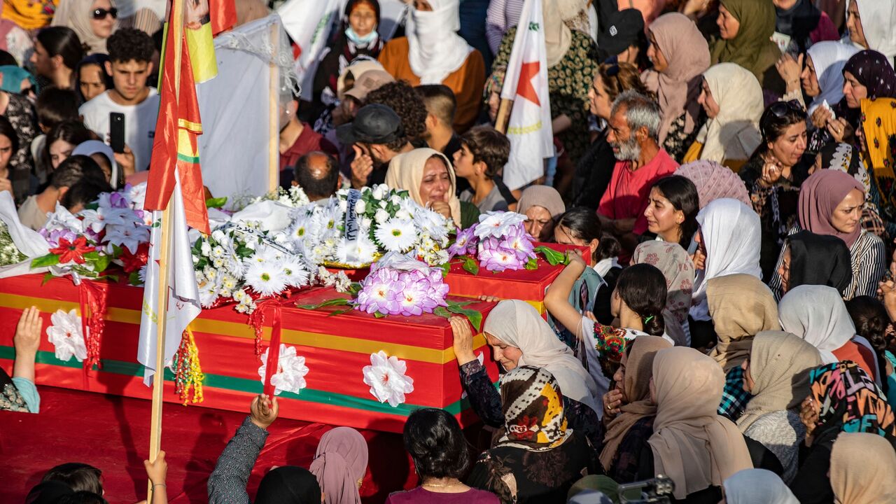 Mourners carry the coffins of two Kurdish women killed a day earlier in a reported Turkish drone strike, during their funeral in Amuda, a town in the Hasakah governorate in northeastern Syria, on June 21, 2023. 