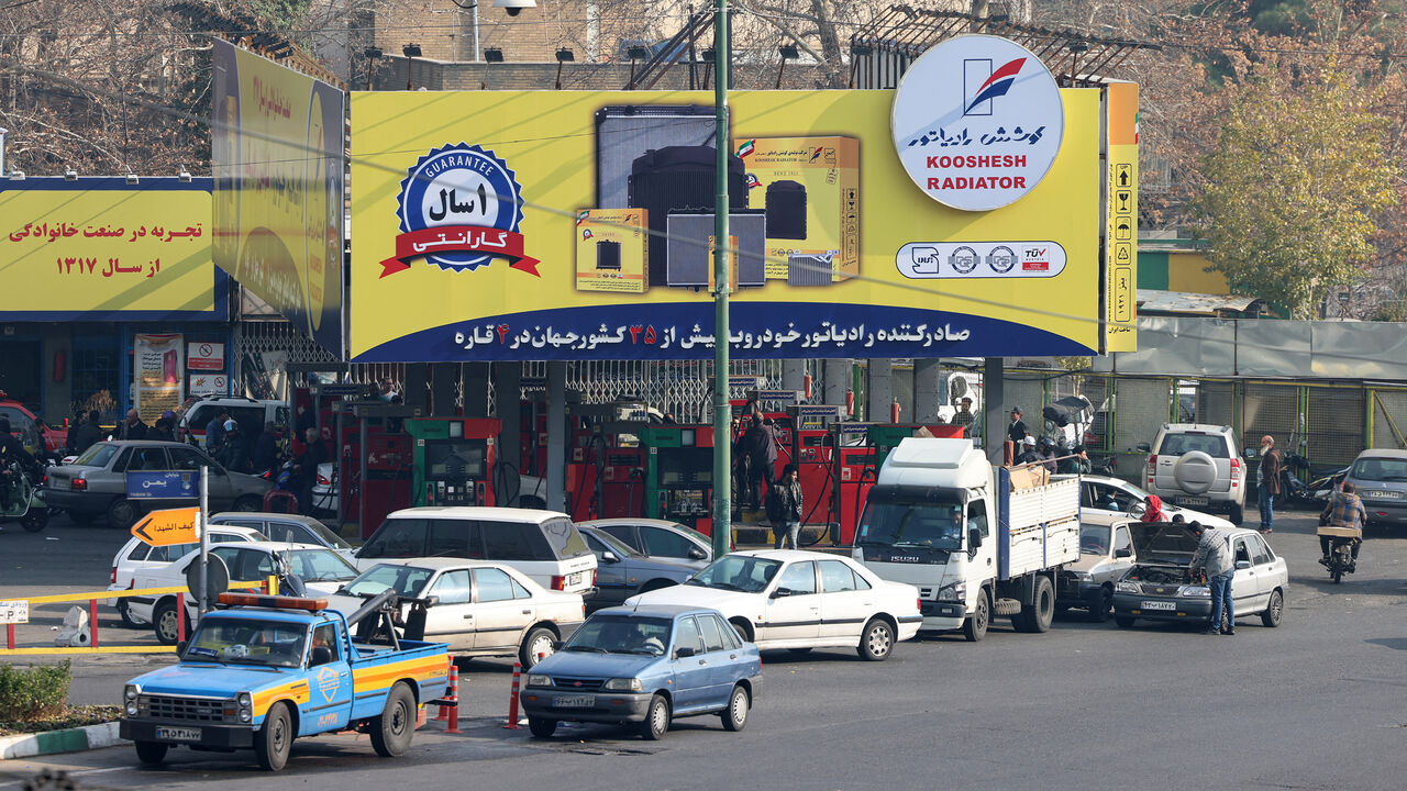 People wait at a gas station as fuel distribution across more than 70% of gas stations is disrupted, Tehran, Iran, Dec. 18, 2023.