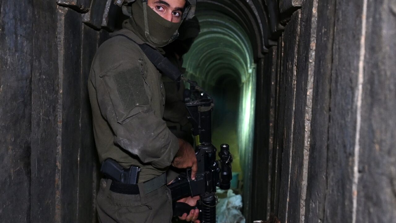 In a photo taken under Israeli army supervision, a soldier stands in what the Israeli army says is a tunnel dug by Hamas militants inside the Al-Shifa hospital complex