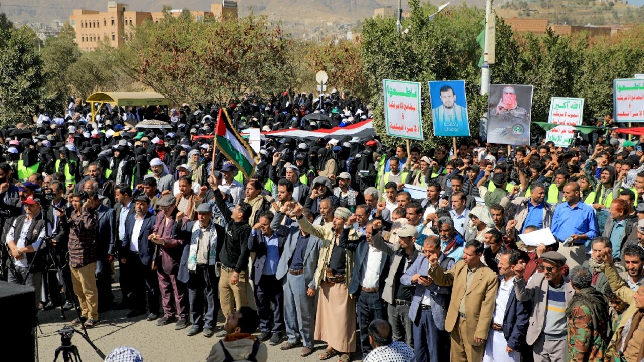 People wave Palestinian and Yemeni flags as they chant anti-Israel and anti-US slogans during a protest in solidarity with the Palestinian people in the Huthi-controlled capital Sanaa on January 17, 2024