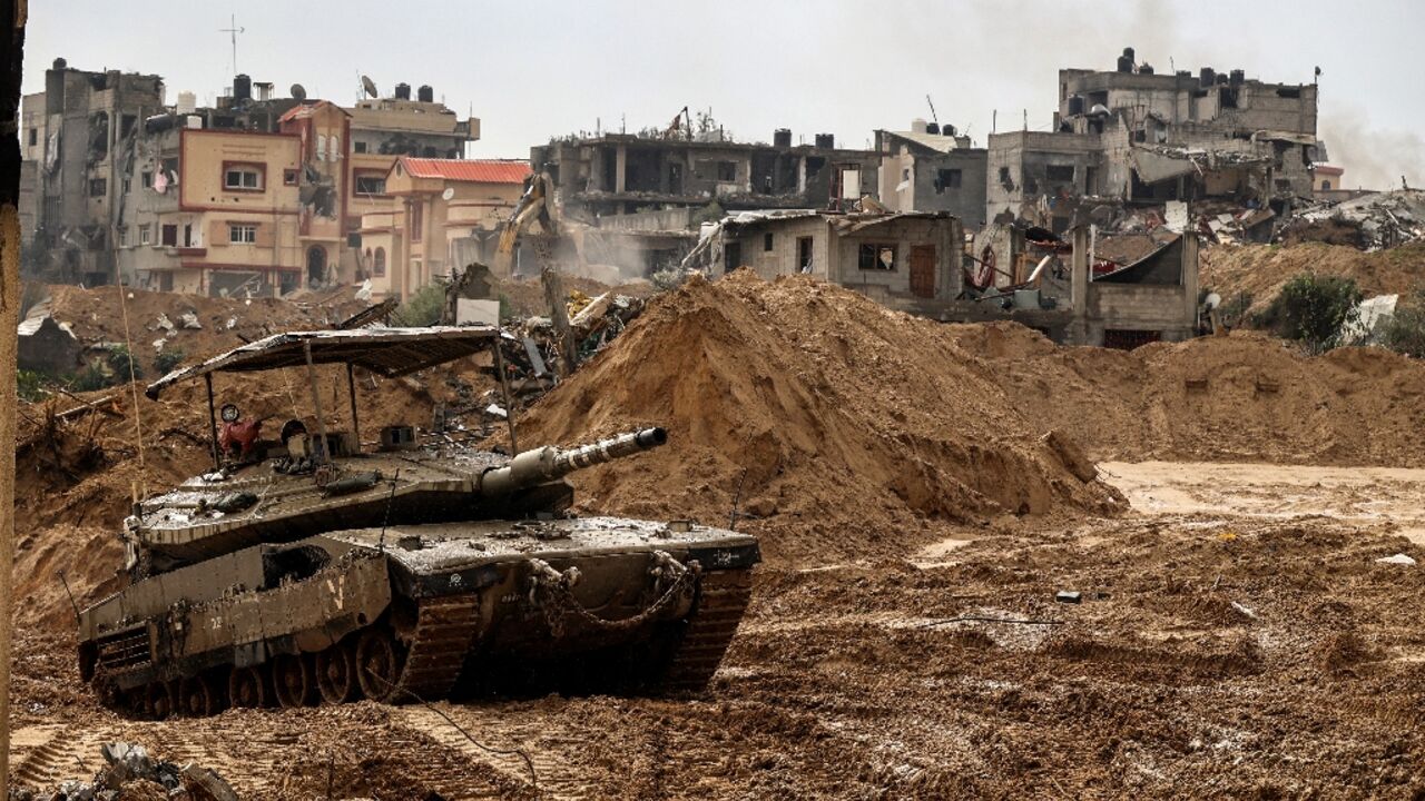 This picture taken during a media tour organised by the Israeli military on January 27, 2024 shows an Israeli army tank rolling in Gaza's main southern city of Khan Yunis