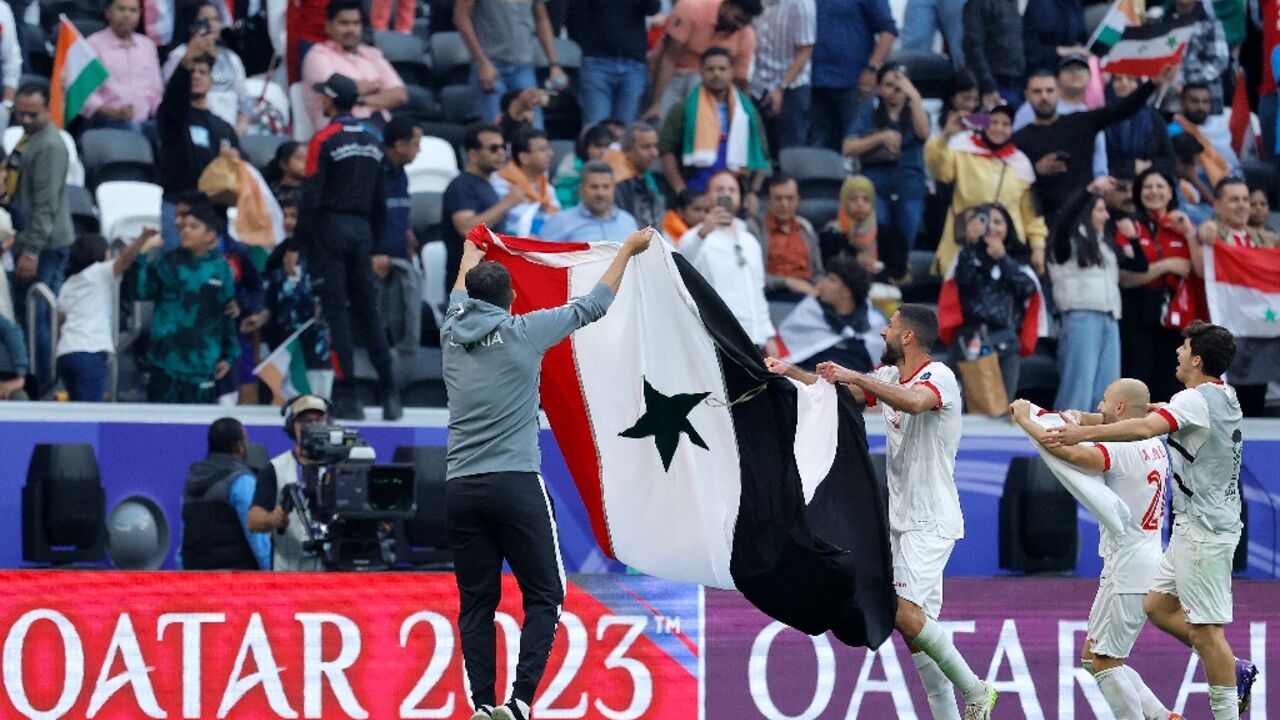 Syria's players celebrate reaching the last 16