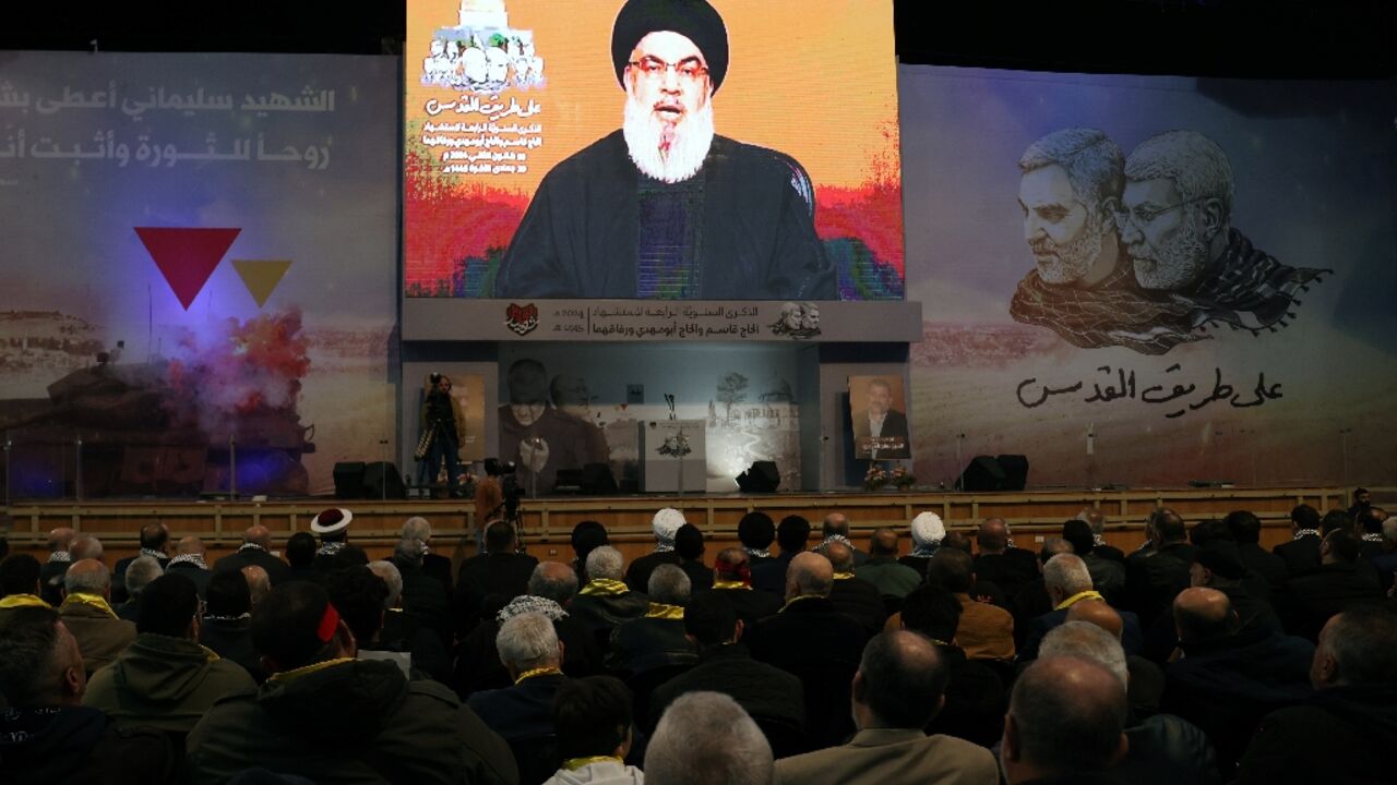 People watch the televised speech of Lebanon's Hezbollah chief Hasan Nasrallah, in southern Beirut on January 3, 2024