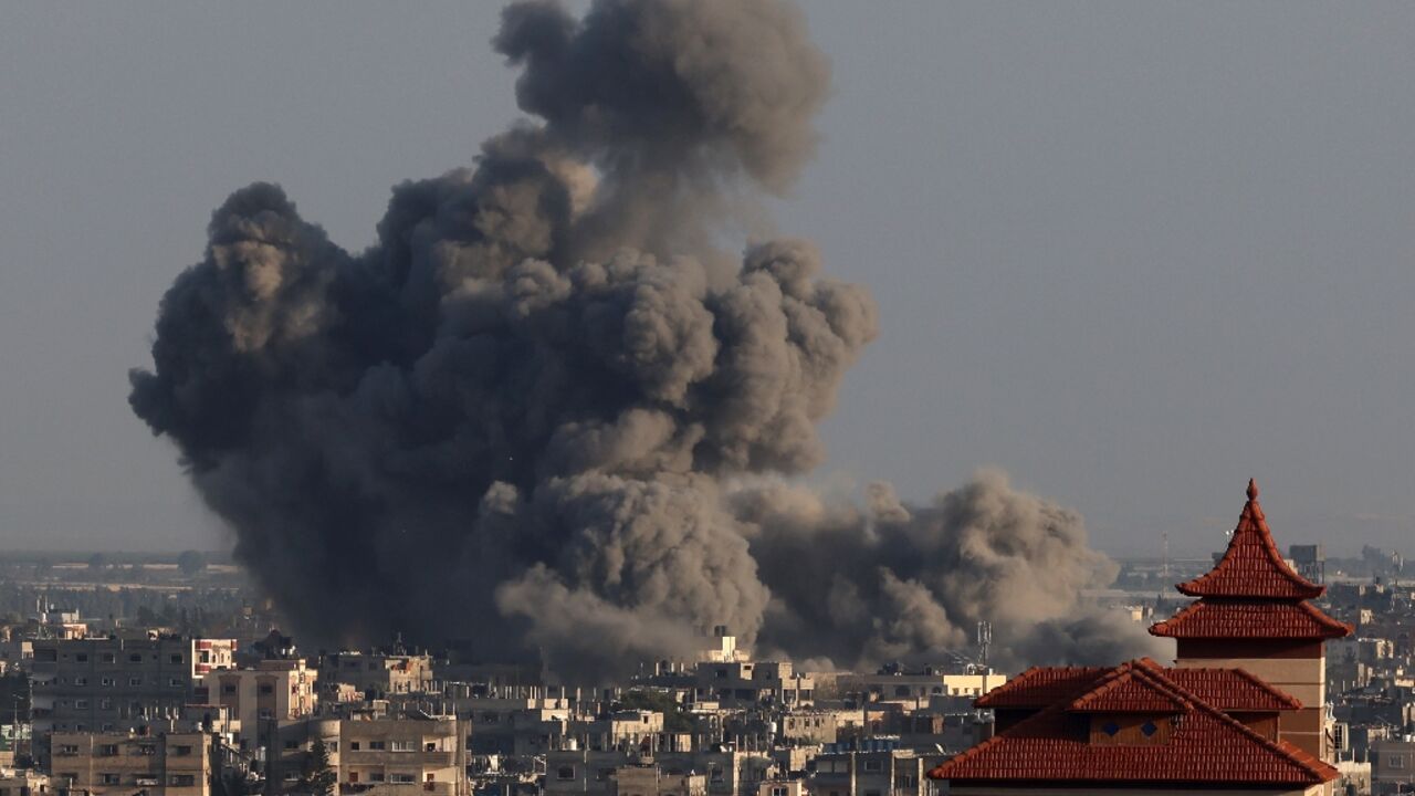Smoke billows over Khan Yunis in the southern Gaza Strip during Israeli bombardments on January 24, 2024