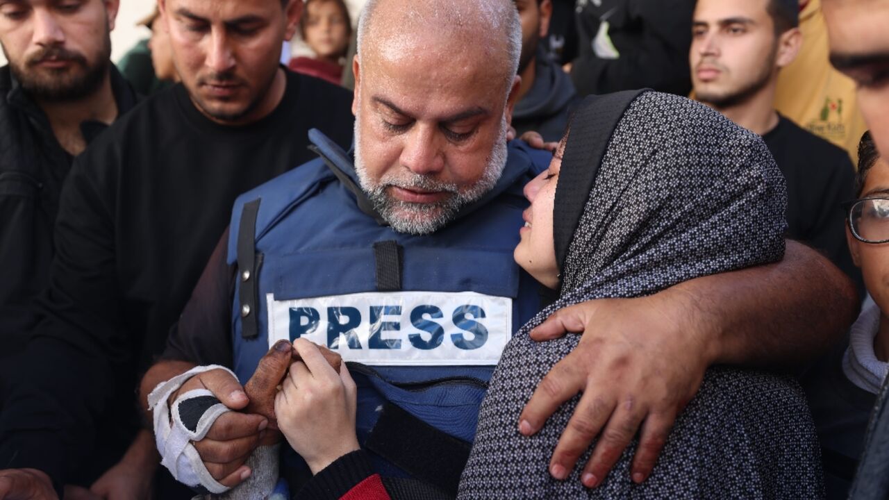 Al Jazeera's bureau chief in Gaza, Wael al-Dahdouh hugs his daughter during the funeral of his son Hamza Wael Dahdouh, a journalist, who was one of two reporters killed in an air strike in Rafah blamed on Israel 