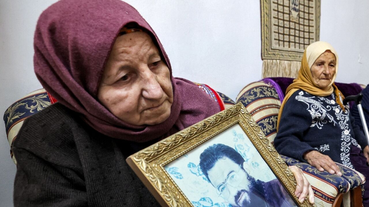 Hamas number two Saleh al-Aruri's mother Aisha clutches a photograph of of her slain son at the family home in Arura, in the Israeli-occupied West Bank