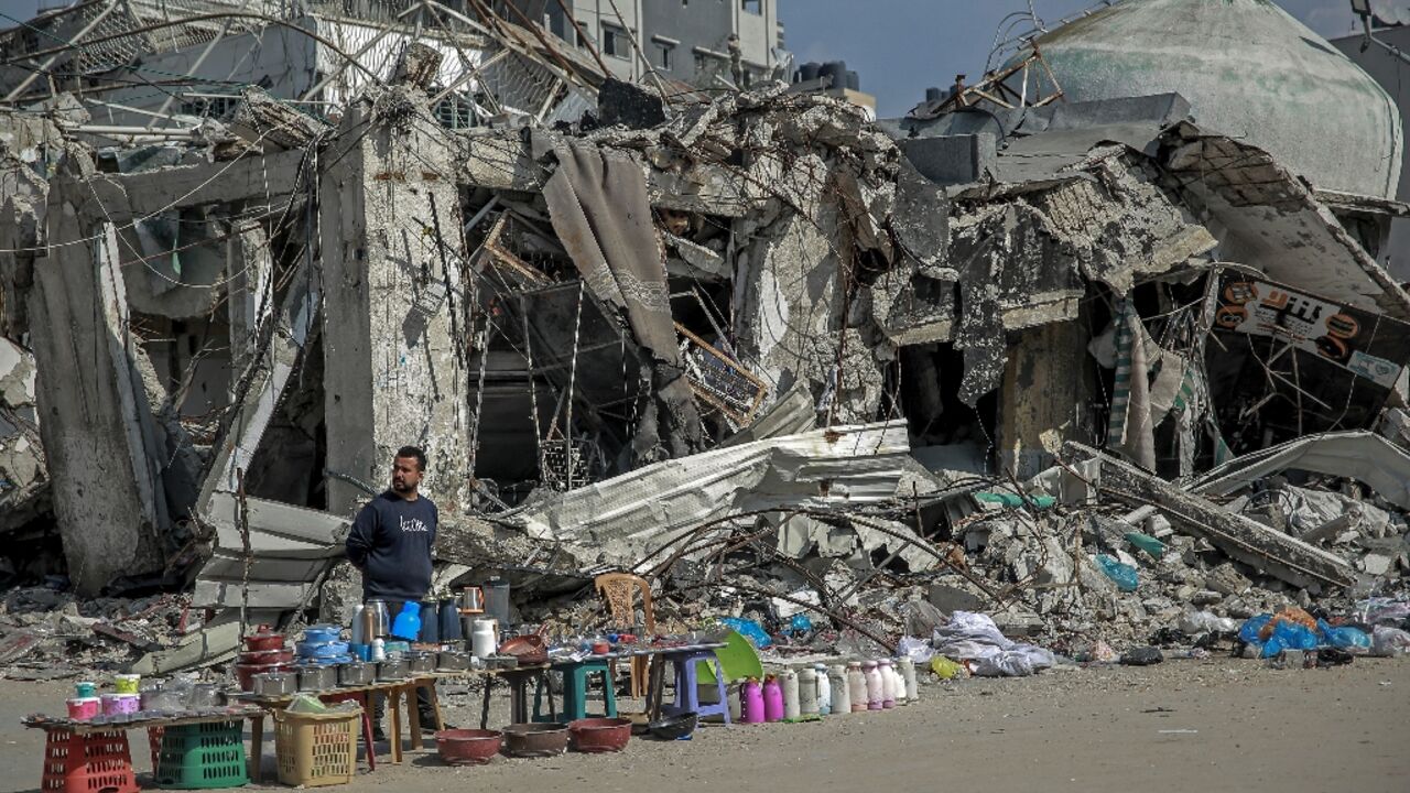 A vendor waits for customers along a street in Gaza City