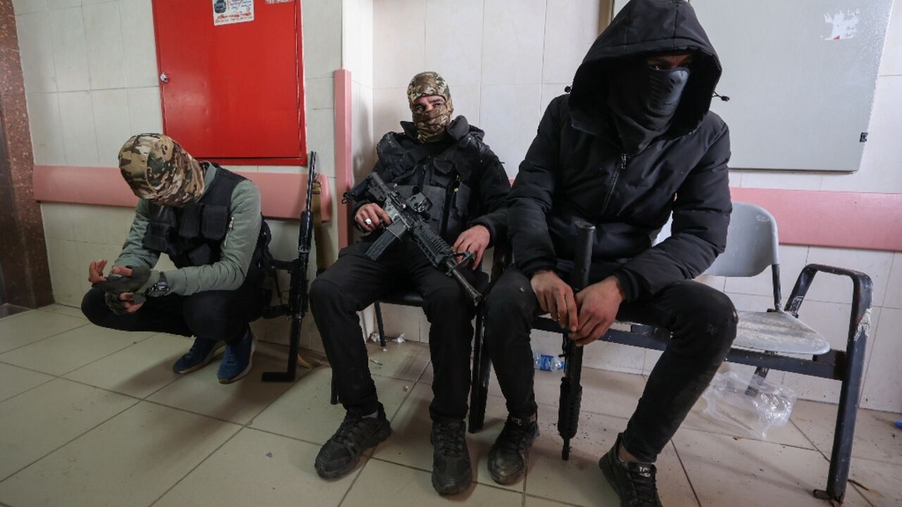 Armed Palestinian militants wait for the funerals of three Palestinians killed in an Israeli raid on the Faraa refugee camp near the West Bank town of Tubas