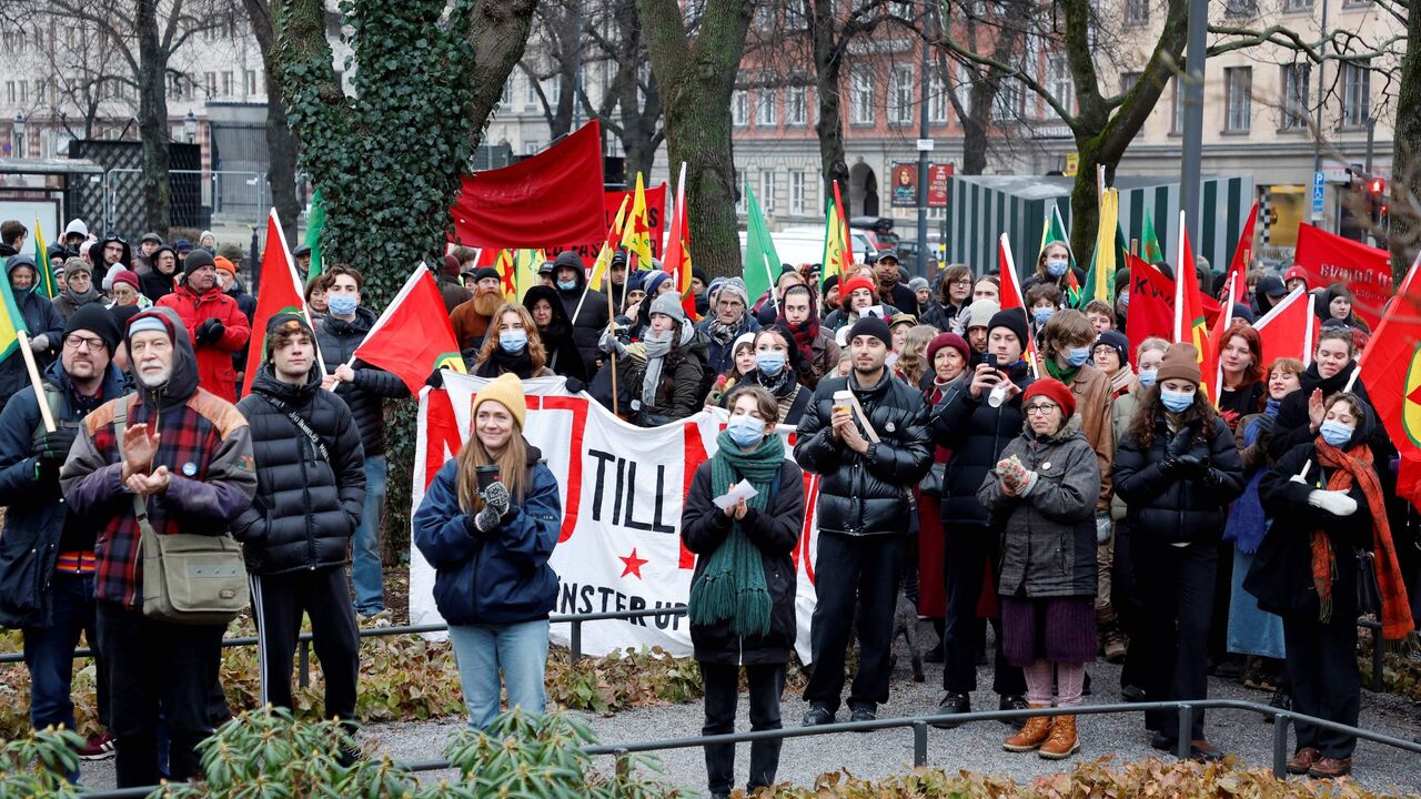 Participants wave flags during a demonstration organized by The Kurdish Democratic Society Center against Turkish President Recep Tayyip Erdogan and Sweden's NATO bid at Norra Bantorget square in Stockholm on January 21, 2023. 