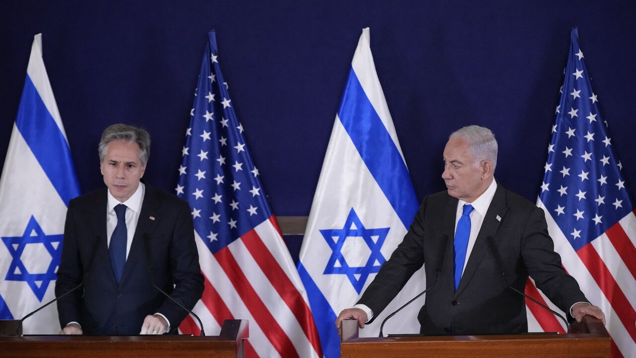 Israeli Prime Minister Benjamin Netanyahu (R) looks on as US Secretary of State Antony Blinken gives statements to the media inside The Kirya, which houses the Israeli Defence Ministry, after their meeting in Tel Aviv on Oct. 12, 2023. 