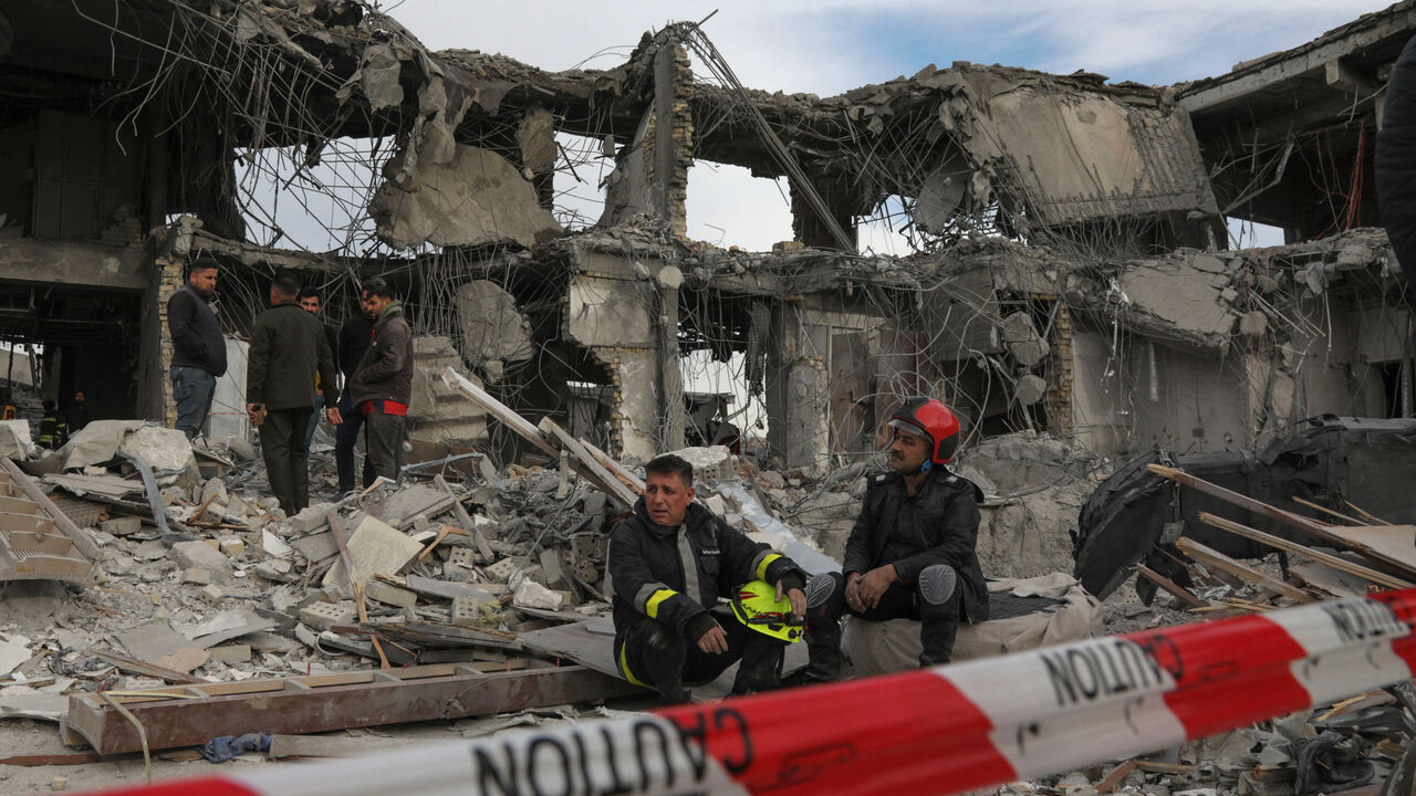 A civil defence team carries out search and rescue operations in a damaged building following a missile strike launched by Iran's Revolutionary Guard Corps (IRGC) on the Kurdistan region's capital of Arbil, on January 17, 2024. The IRGC have launched missile attacks on multiple "terrorist" targets in Syria and in Iraq's autonomous Kurdistan region, Iranian state media reported on January 16