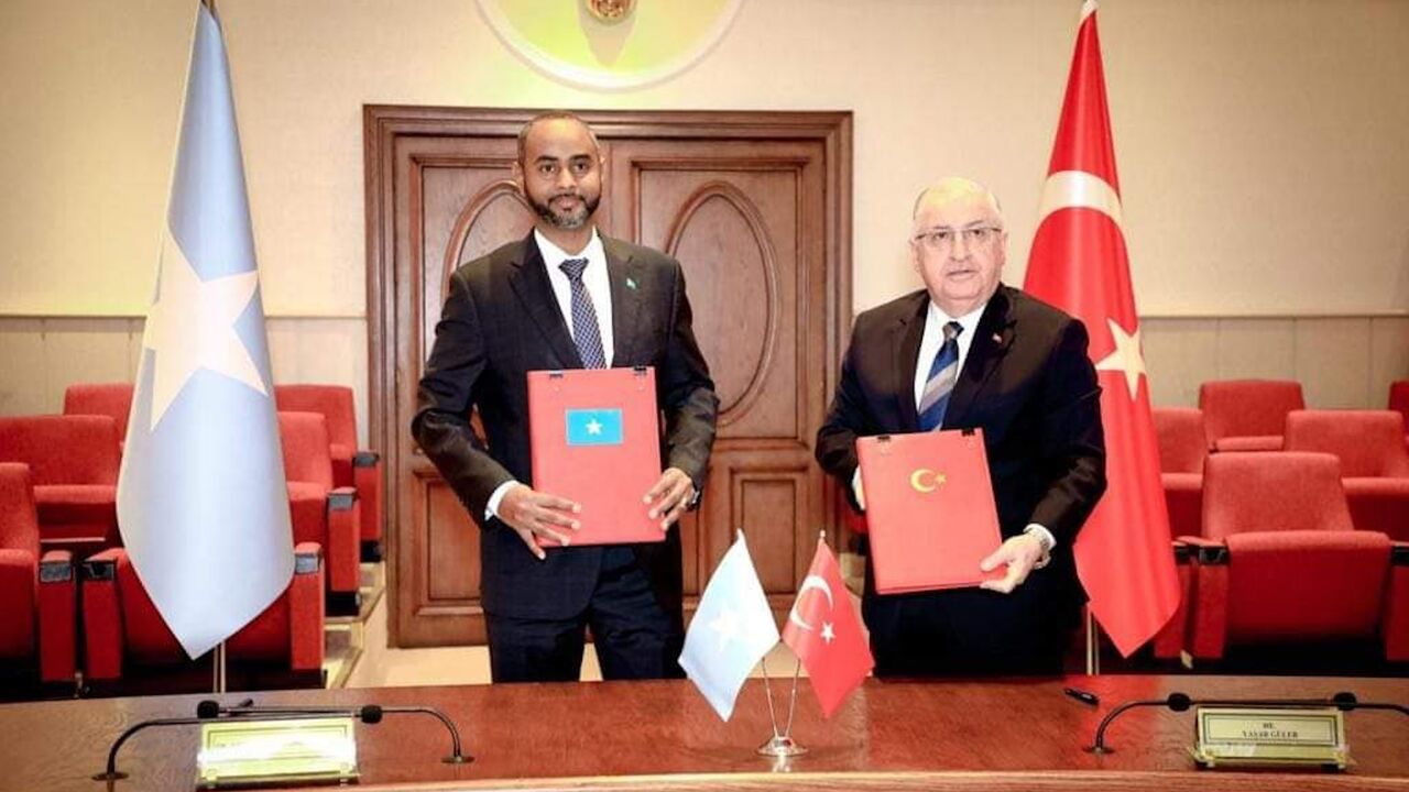 Abdikadir Mohamed Nour (L), the minister of defense of Somalia, signs a security pact with Turkiye’s Minister of Defense Yasar Guler, on Feb. 8, 2024.