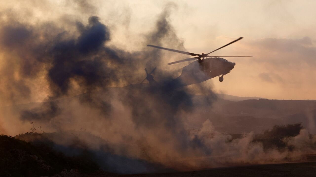 An Israeli helicopter takes off during a military exercise in Upper Galilee near the Lebanon border on February 7, 2024