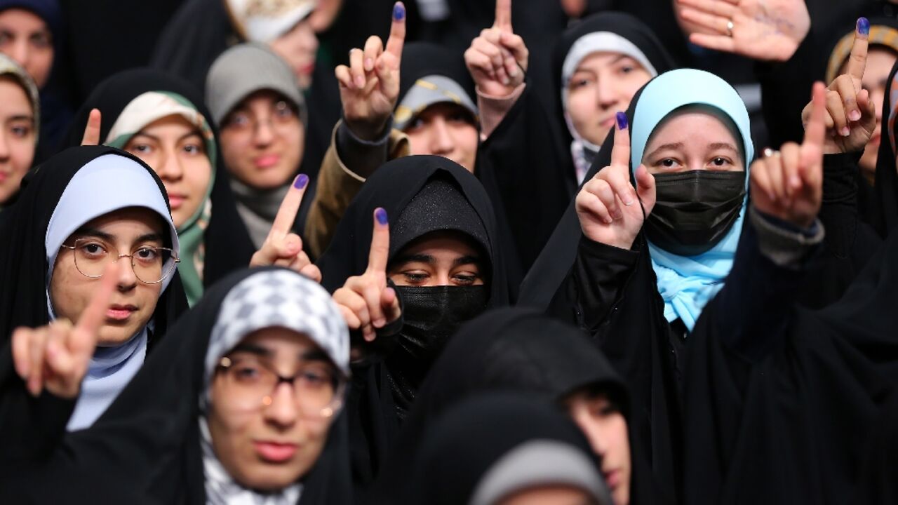 Young Iranian women eligible to vote for the first time show ink-stained fingers in a picture provided by the office of Iran's Supreme Leader Ayatollah Ali Khamenei