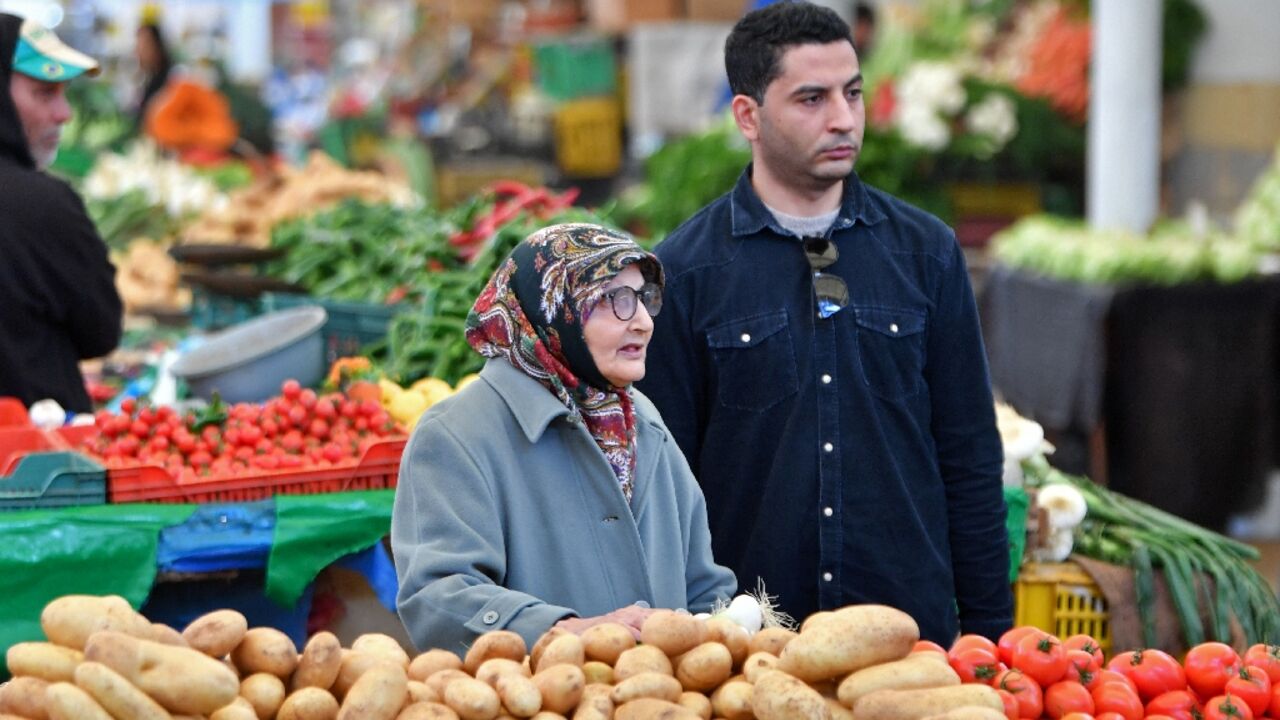 Tunisians shop for vegetables in the capital's central market