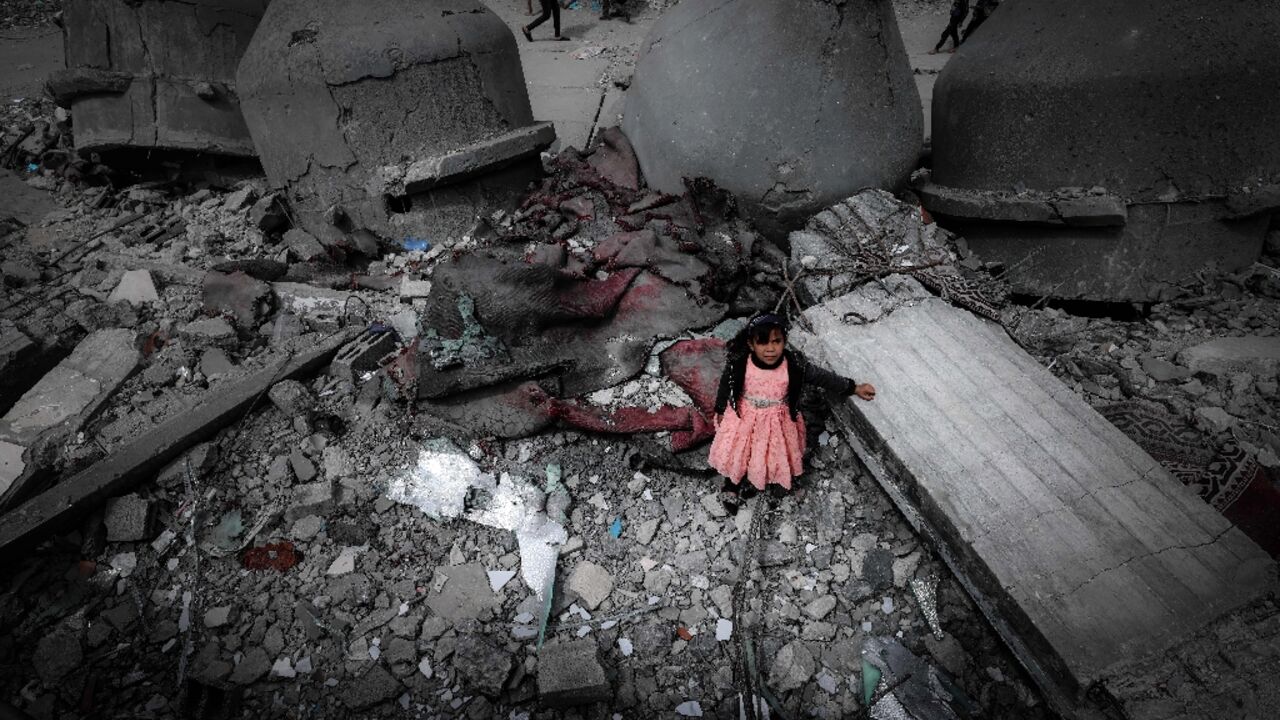 A Palestinian girl stands in the ruins of the Al-Faruq Mosque in Rafah on Friday