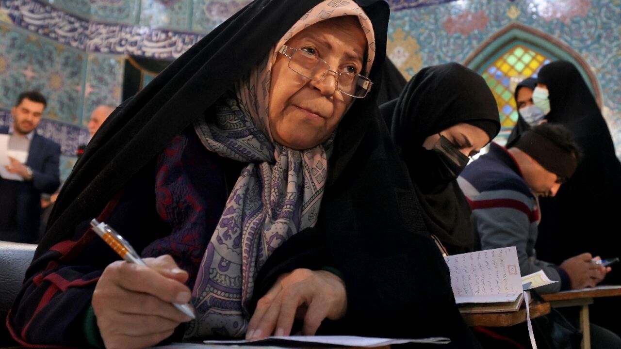 Iranian women fill out their ballots in the election for which local Fars news agency estimated turnout at 'more than 40 percent'