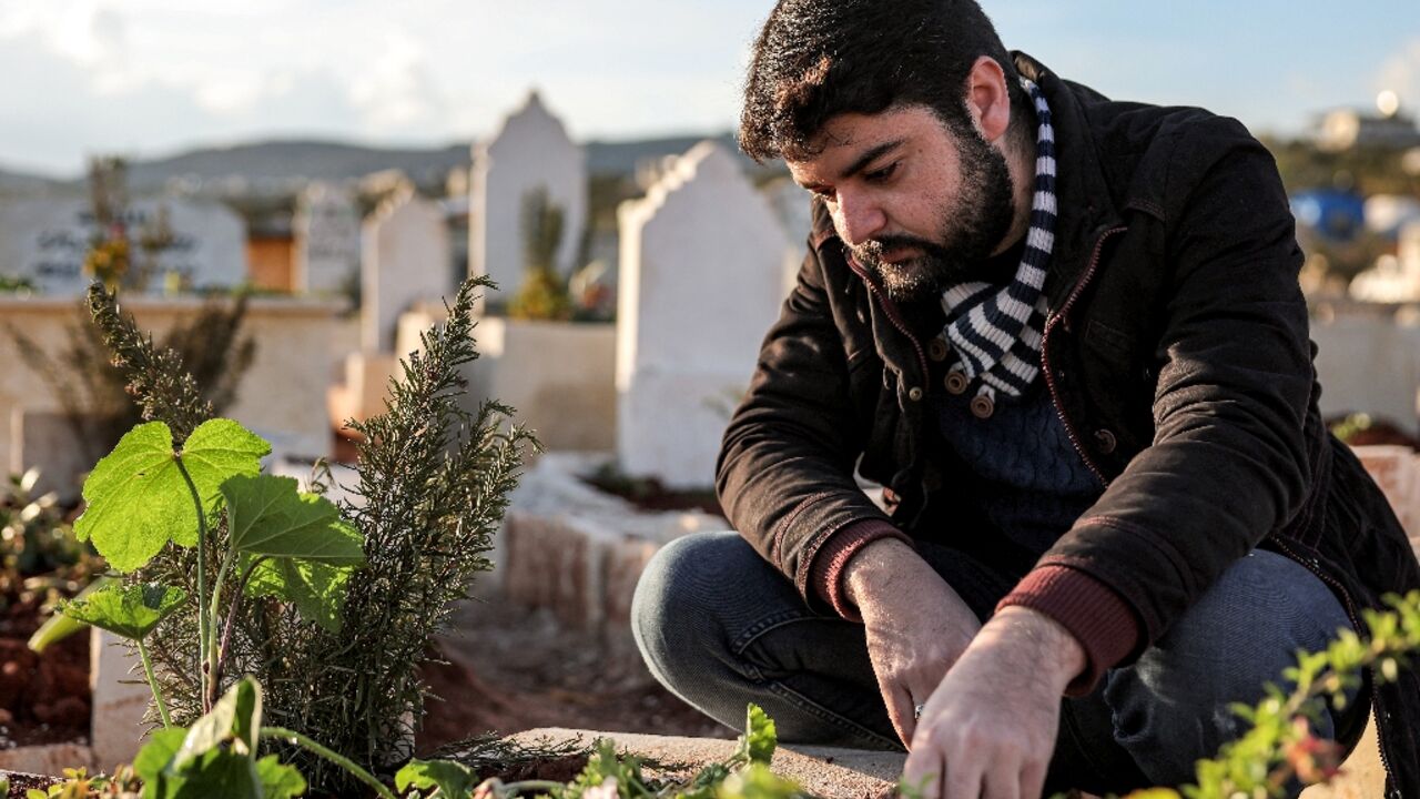 Ahmed al-Hakim by the tomb of his brother, whose death triggered rare protests in Syria's Idlib province