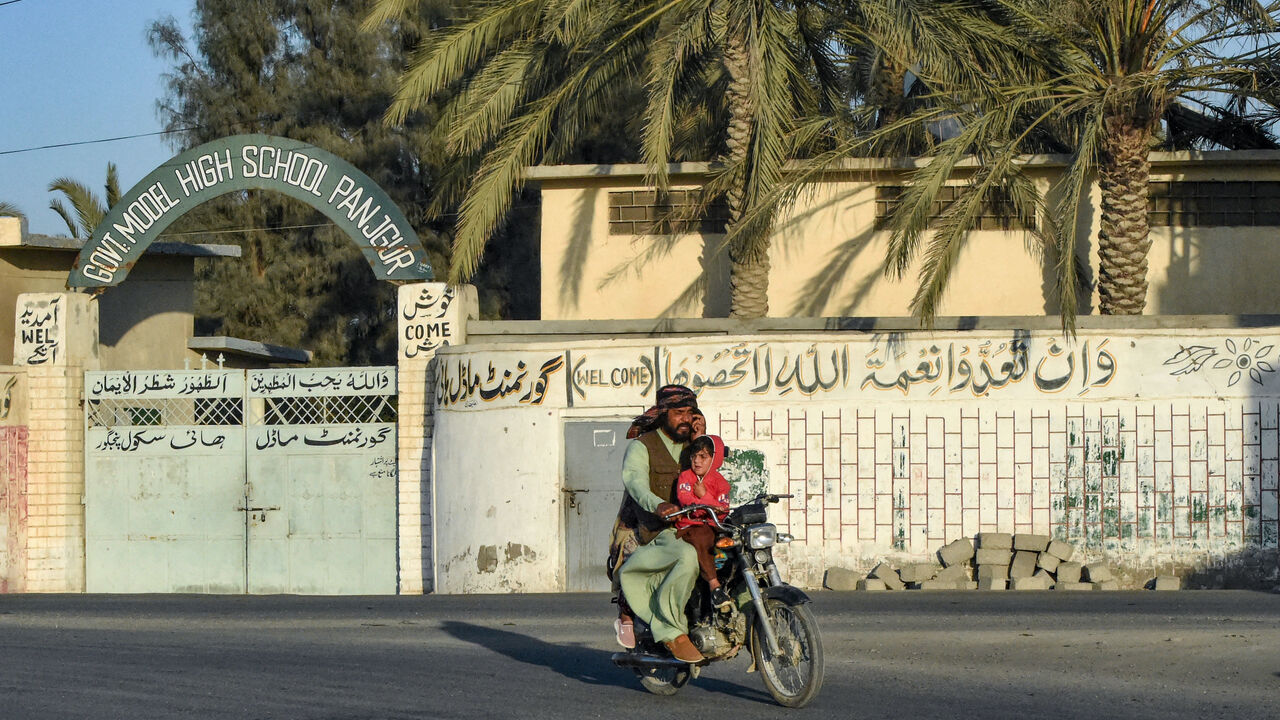 A motorcyclist rides past a high school at Panjgur district in Balochistan province on Jan. 17, 2024. Pakistan recalled its ambassador from Iran on Jan. 17, and blocked Tehran's envoy from returning to Islamabad after an Iranian air strike killed two children in the west of the country on Jan. 16.