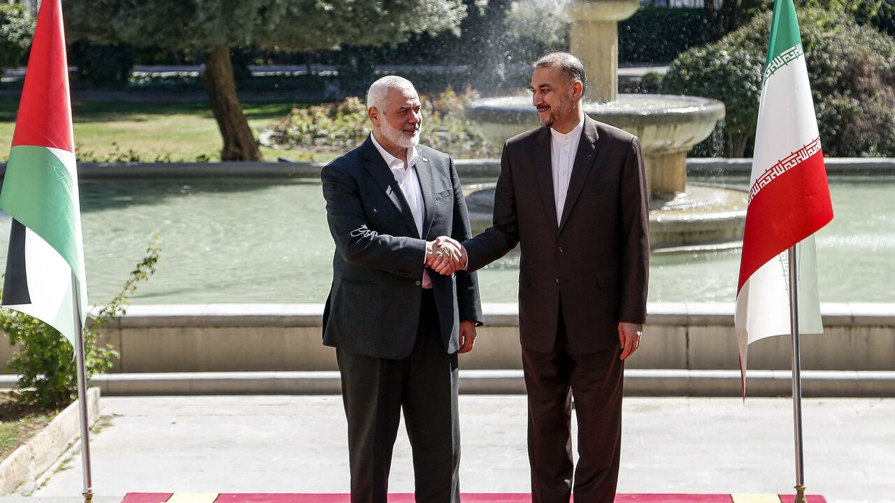 Iran's Foreign Minister Hossein Amir-Abdollahian (R) receives Hamas' Doha-based political bureau chief Ismail Haniyeh.