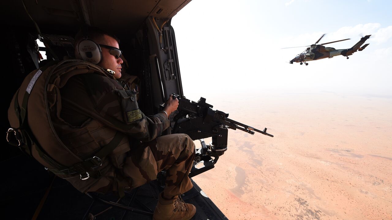 A French soldier of the operation Barkhane, an anti-terrorist mission in Sahel, patrols as a tiger helicopter operates a tactical flight on March 12, 2016 in Mali. France's Barkhane counter-terror mission comprises at least 3,500 soldiers deployed across five countries (Mauritania, Mali, Niger, Chad and Burkina Faso) with a mandate to combat jihadist insurgencies in the region. 