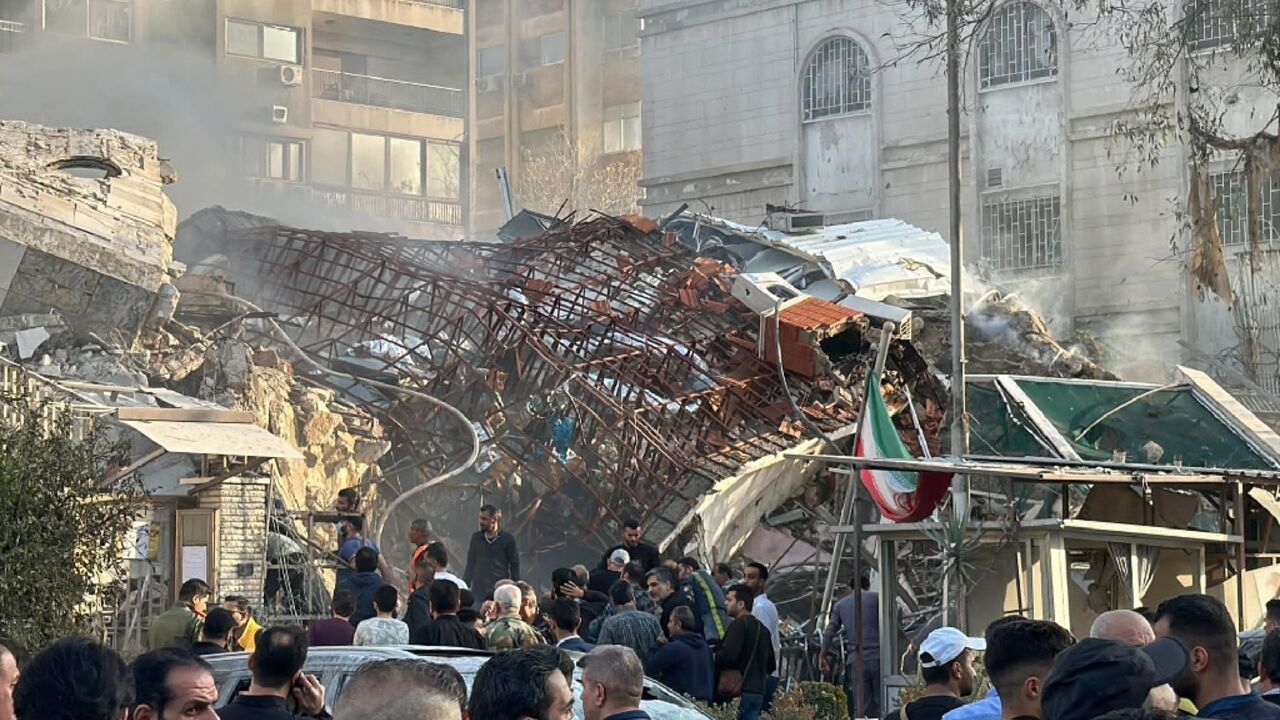 Emergency and security personnel gather at the site of strikes which hit a building adjacent to the Iranian embassy in Syria's capital Damascus, on April 1, 2024