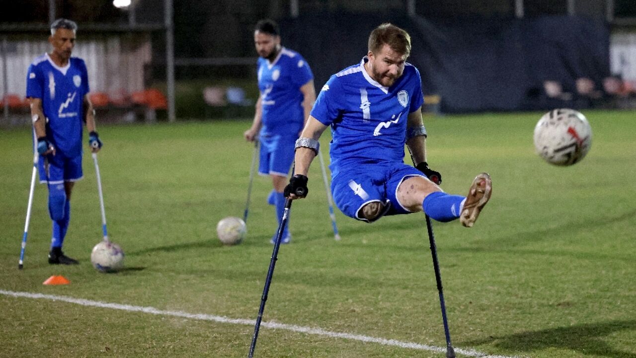 Ben Binyamin 29, shoots at goal during training with the Israeli amputee football team