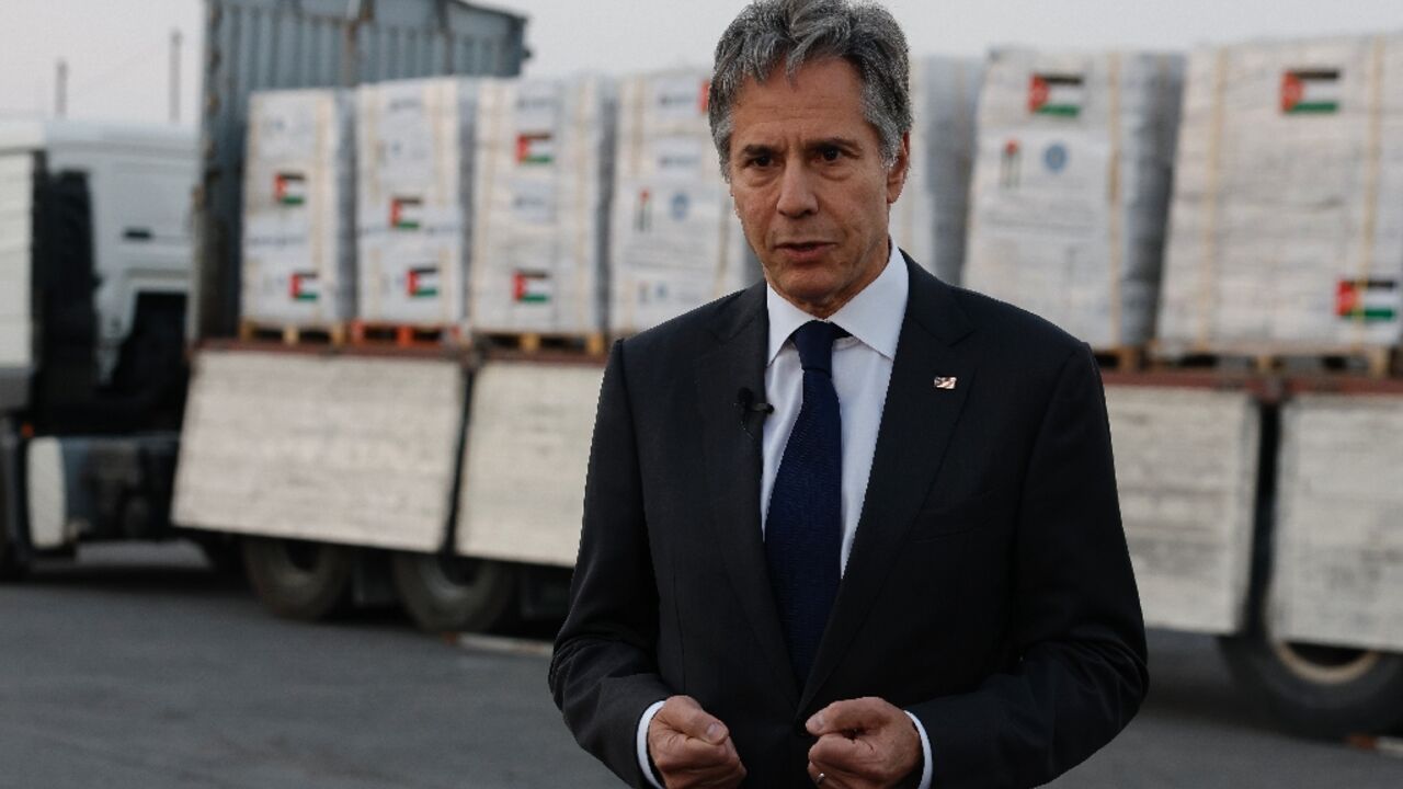 US Secretary of State Antony Blinken speaks to the press in front of a truck with humanitarian aid bound for Gaza 