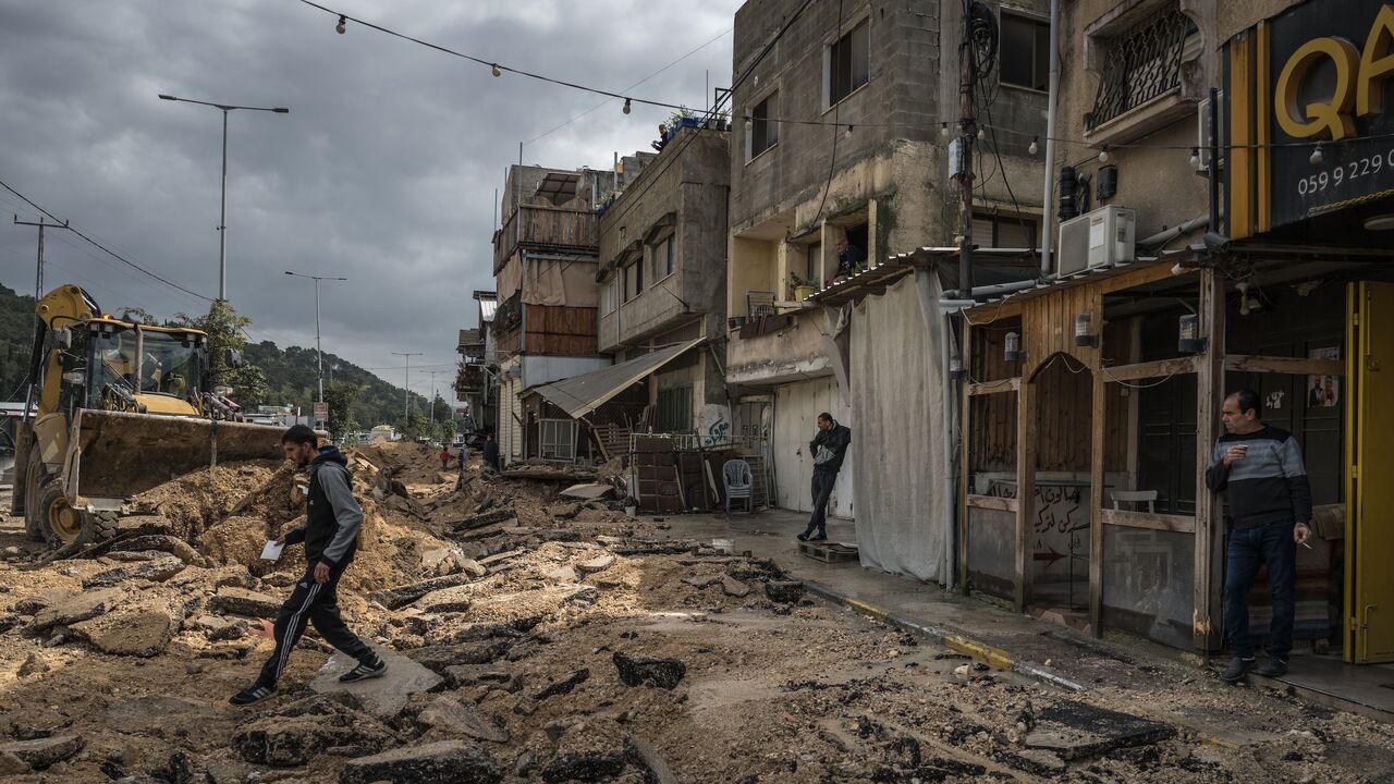 Palestinians survey a destroyed pavement following an Israeli raid in the Nur Shams camp near Tulkarm on March 4, 2024, West Bank.