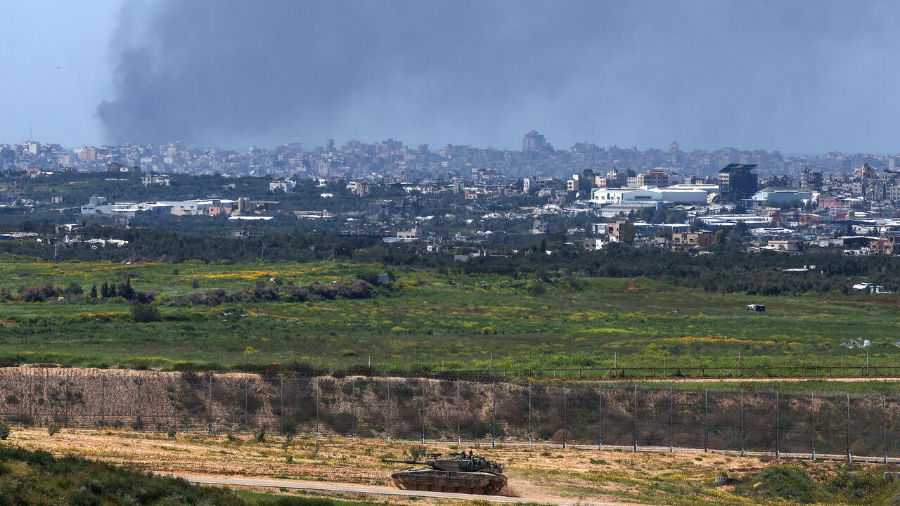 This picture taken from Israel's southern border with the Gaza Strip shows an Israeli tank moving along the border with the Palestinian territory on March 20, 2024, amid the ongoing conflict between Israel and the militant group Hamas. 