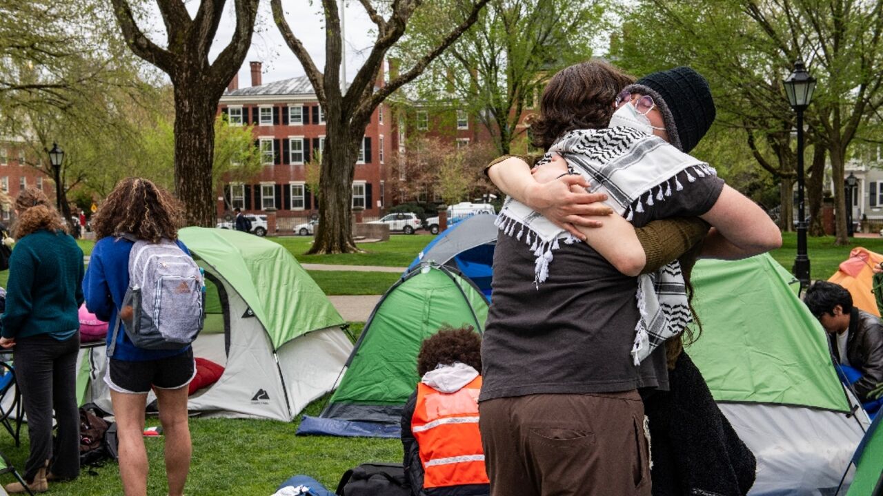Pro-Palestinian students embrace each other as they take down their encampment after reaching a deal with Brown University in Providence, Rhode Island