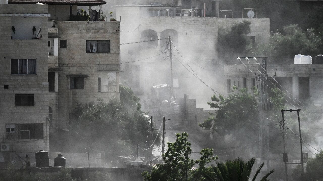 Smoke billowed over the refugee camp in Jenin after an Israeli raid killed at least seven Palestinians