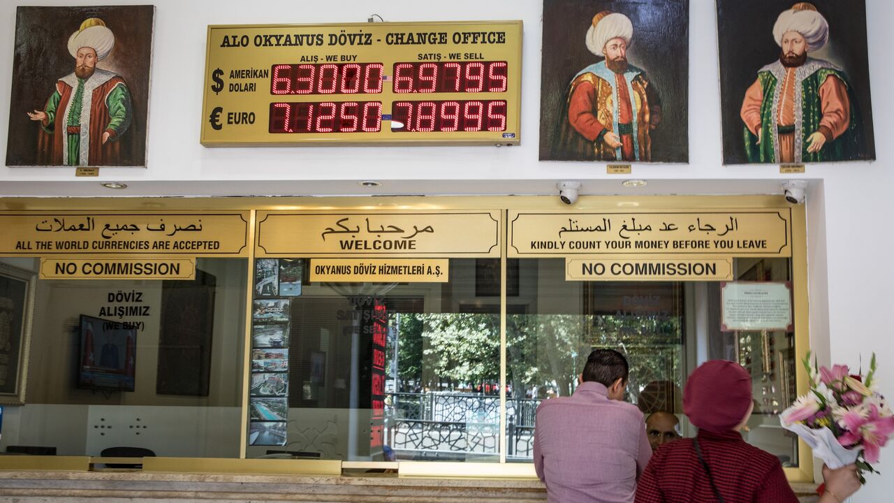 People exchange money at a currency exchange office on Aug. 13, 2018, in Istanbul, Turkey. 