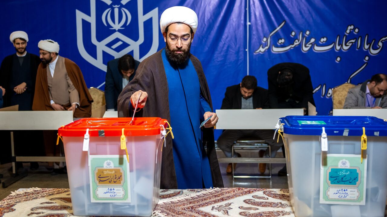 Iranians participate in the 12th term parliamentary elections and the 6th term Assembly of Leadership Experts' voting at a Tehran polling station on March 1, 2024. 