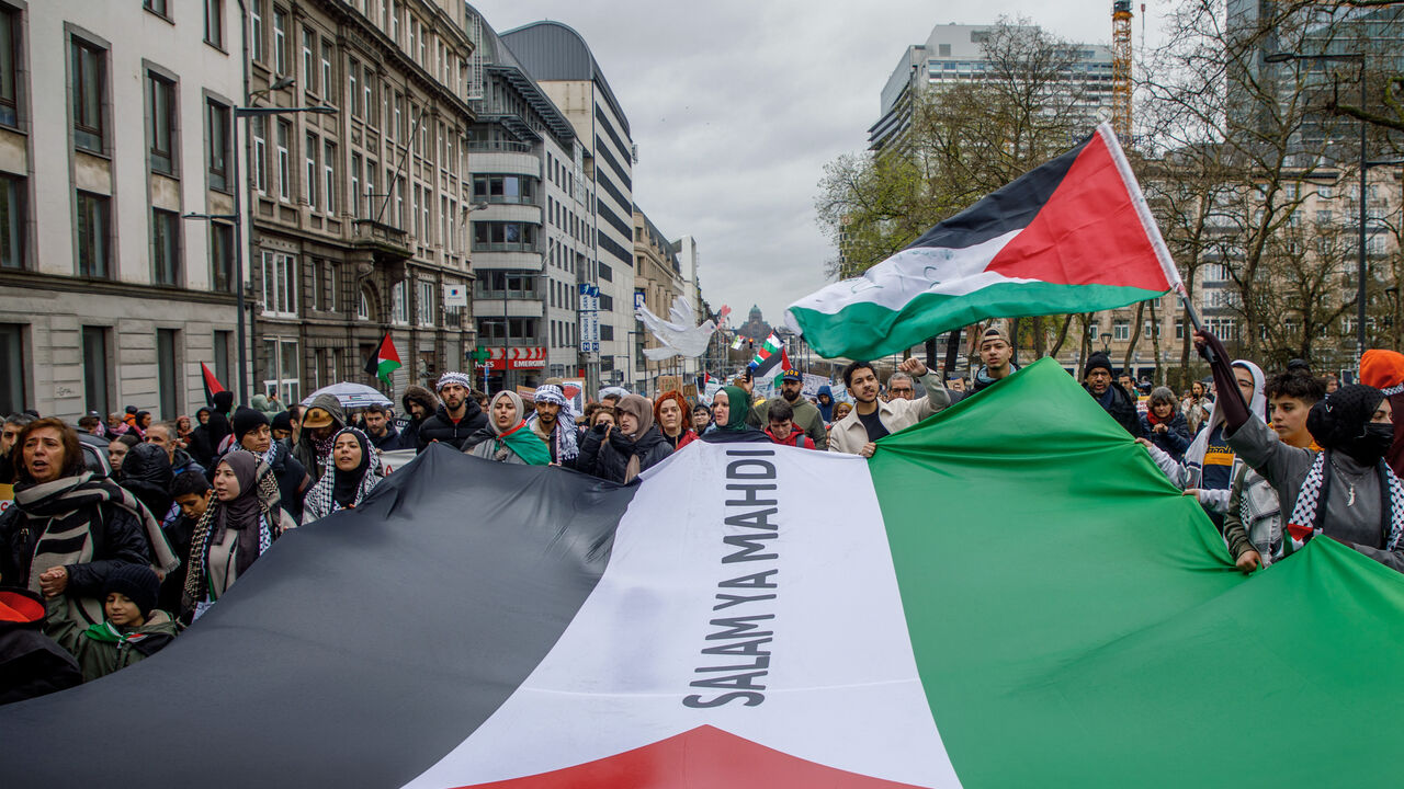 Demonstrators hold a giant Palestinian flag during the 'Justice for Palestine' rally in solidarity with the Palestinian people in Brussels on March 17, 2024. (Photo by HATIM KAGHAT / Belga / AFP) / Belgium OUT (Photo by HATIM KAGHAT/Belga/AFP via Getty Images)