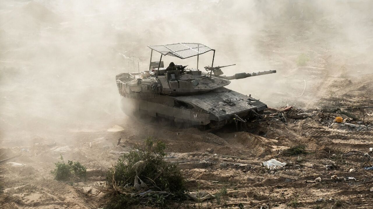 An Israeli tank is seen during operations around Jabalia in the northern Gaza Strip