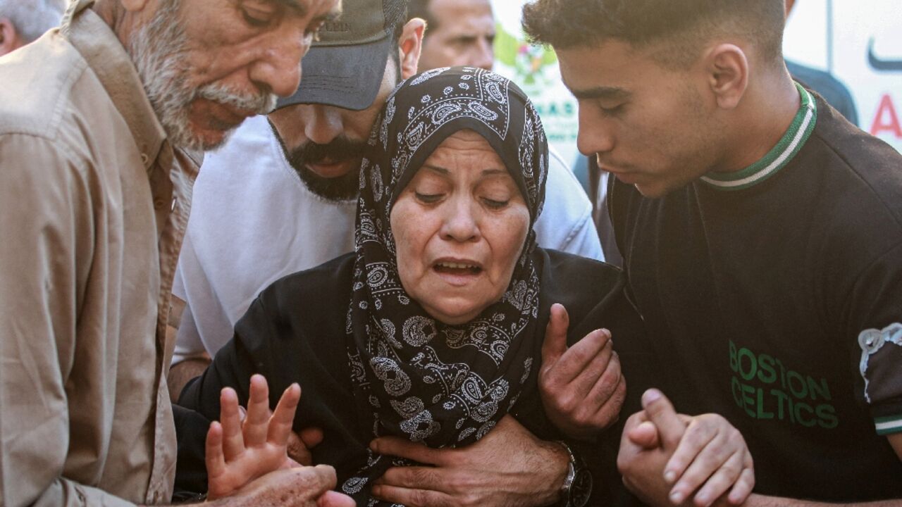 A Palestinian woman mourns her relative, killed in an Israeli strike in central Gaza's Deir al-Balah