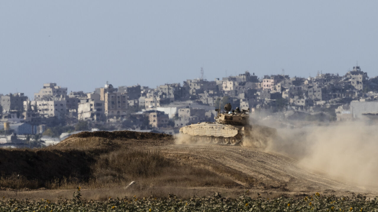 SOUTHERN ISRAEL, ISRAEL - JUNE 17: An Israeli tank moves along the border with the Gaza Strip as seen from a position on the Israeli side of the border on June 17, 2024 in Southern Israel, Israel. Israeli Army have agreed to a daily tactical pause in South Gaza to allow the passage of Humanitarian aid across the border. (Photo by Amir Levy/Getty Images)