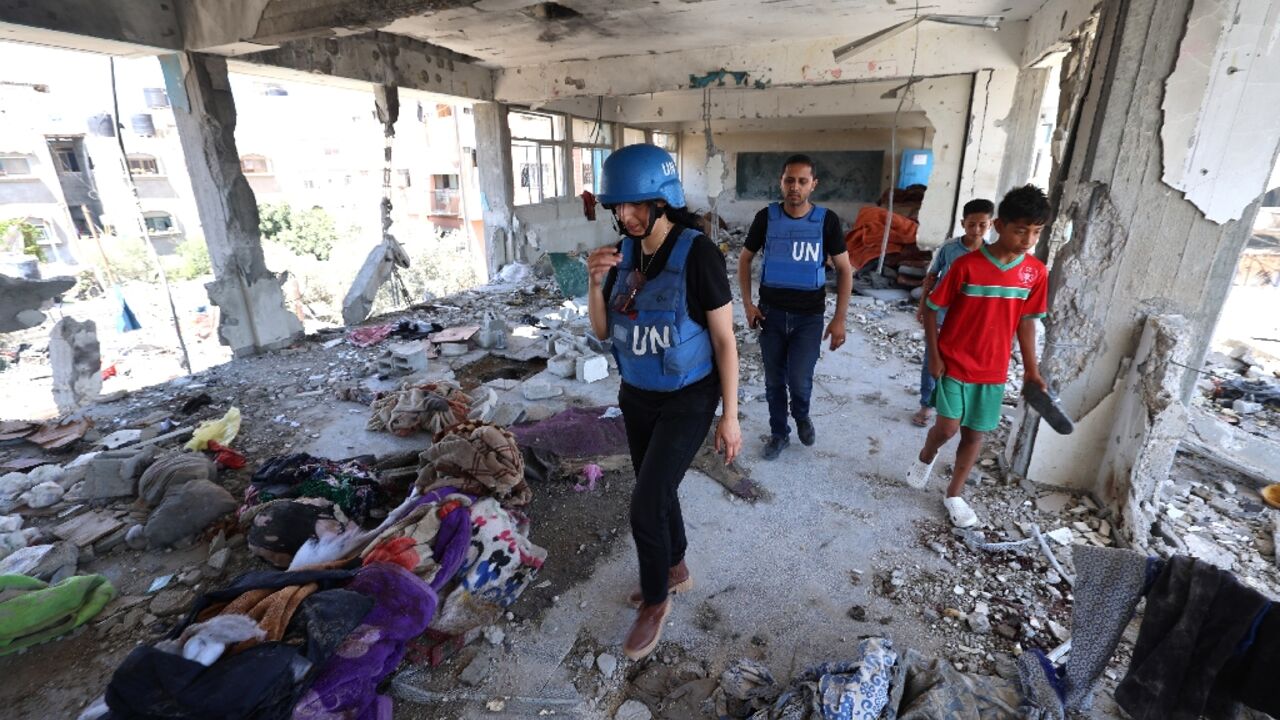 Members of a UN investigation team visit the UNRWA-run school hit by an Israeli air strike
