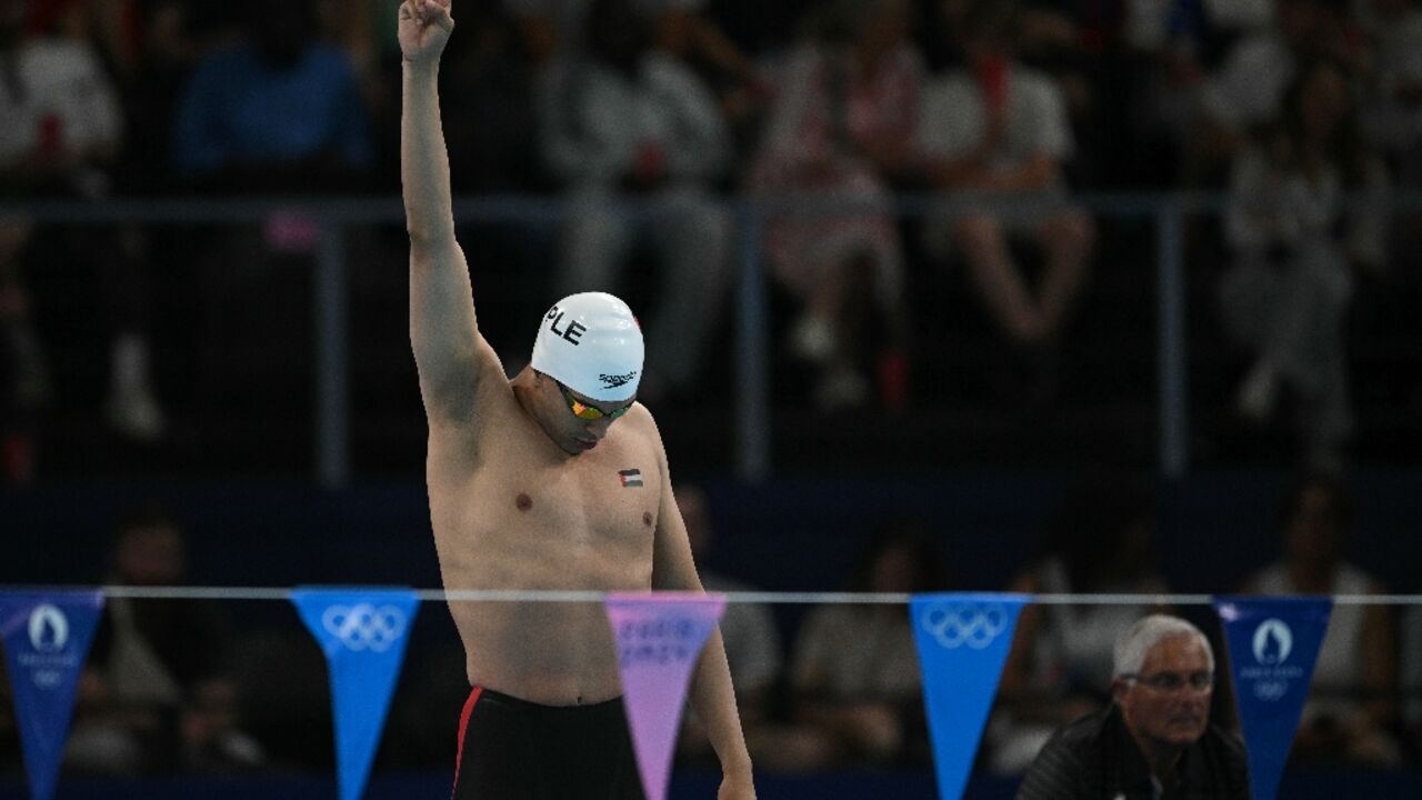 Palestine's Yazan Al Bawwab makes a peace sign ahead of his heat in the 100m backstroke at the Olympics 