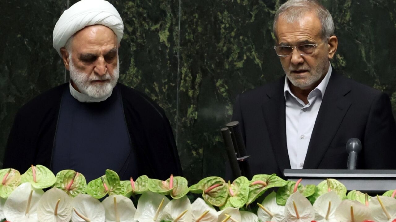 New Iranian President Masoud Pezeshkian (R) was sworn in by parliament on July 30, 2024
