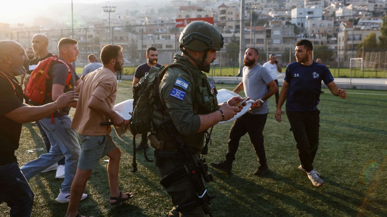 Israel emergency services evacuate the wounded for treatment after rocket fire from Lebanon hits the annexed Golan Heights killing nine people and wounding more than 30