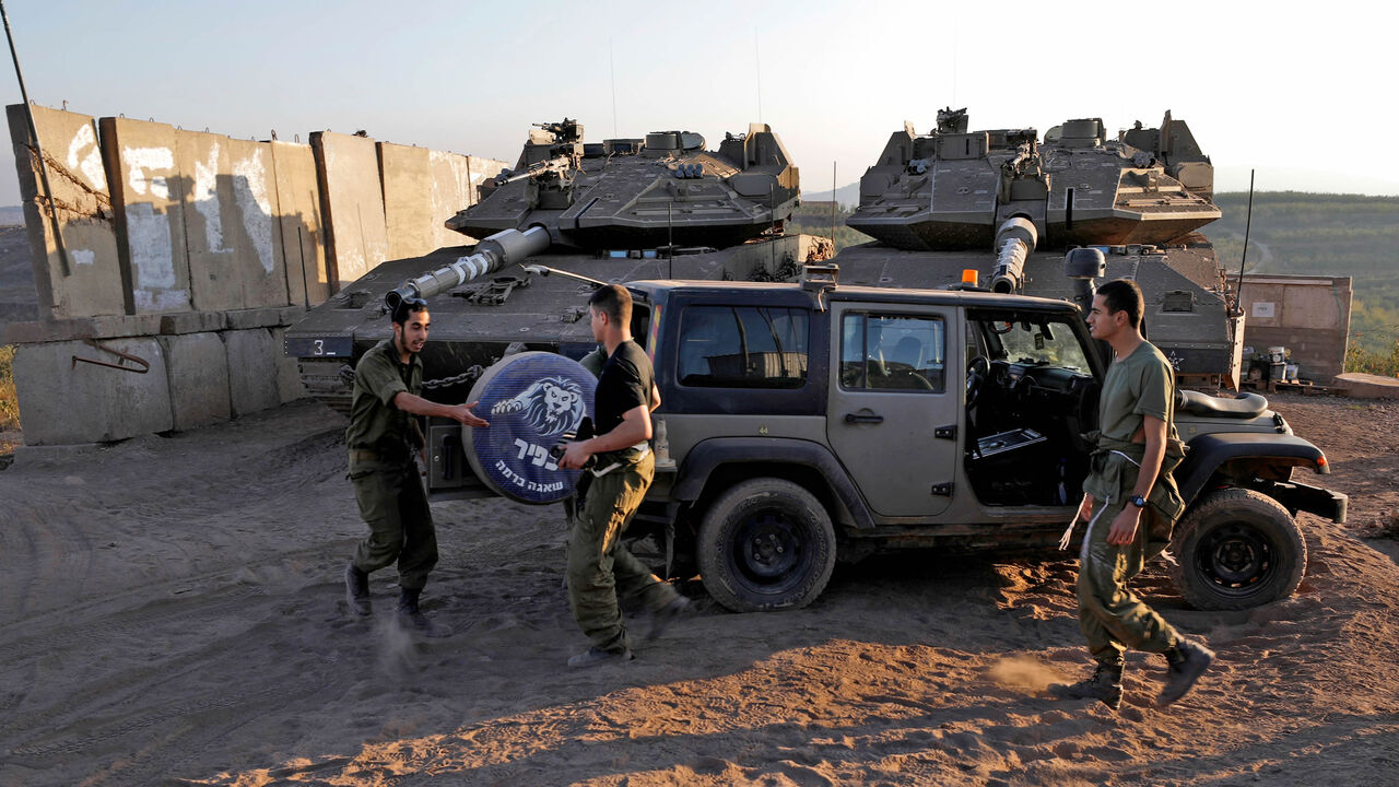 Israeli-armored vehicles take position near the border with Syria in the village of Majdal Shams in the Israel-annexed Golan Heights, Oct. 25, 2021.
