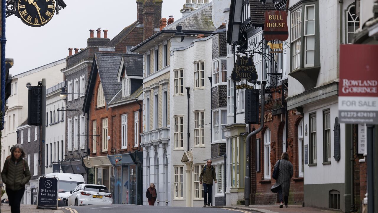 Members of the public walk along the high street on March 21, 2024, in Lewes, England. 