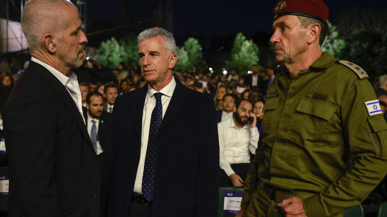 (L-R) Israel's domestic security agency 'Shin Bet' chief Ronen Bar, Mossad Director David Barnea, and army Chief of Staff Herzi Halevi talk as they arrive for a ceremony marking Holocaust Remembrance Day for the six million Jews killed during World War II, at the Yad Vashem Holocaust Memorial in Jerusalem on May 5, 2024. (Photo by Menahem Kahana / AFP) (Photo by MENAHEM KAHANA/AFP via Getty Images)