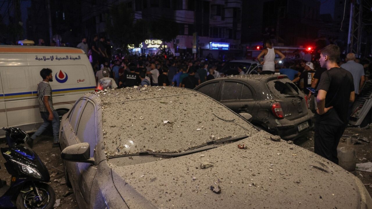 Debris covers a vehicle damaged in an Israeli military strike on Beirut's southern suburbs that targeted a Hezbollah commander 