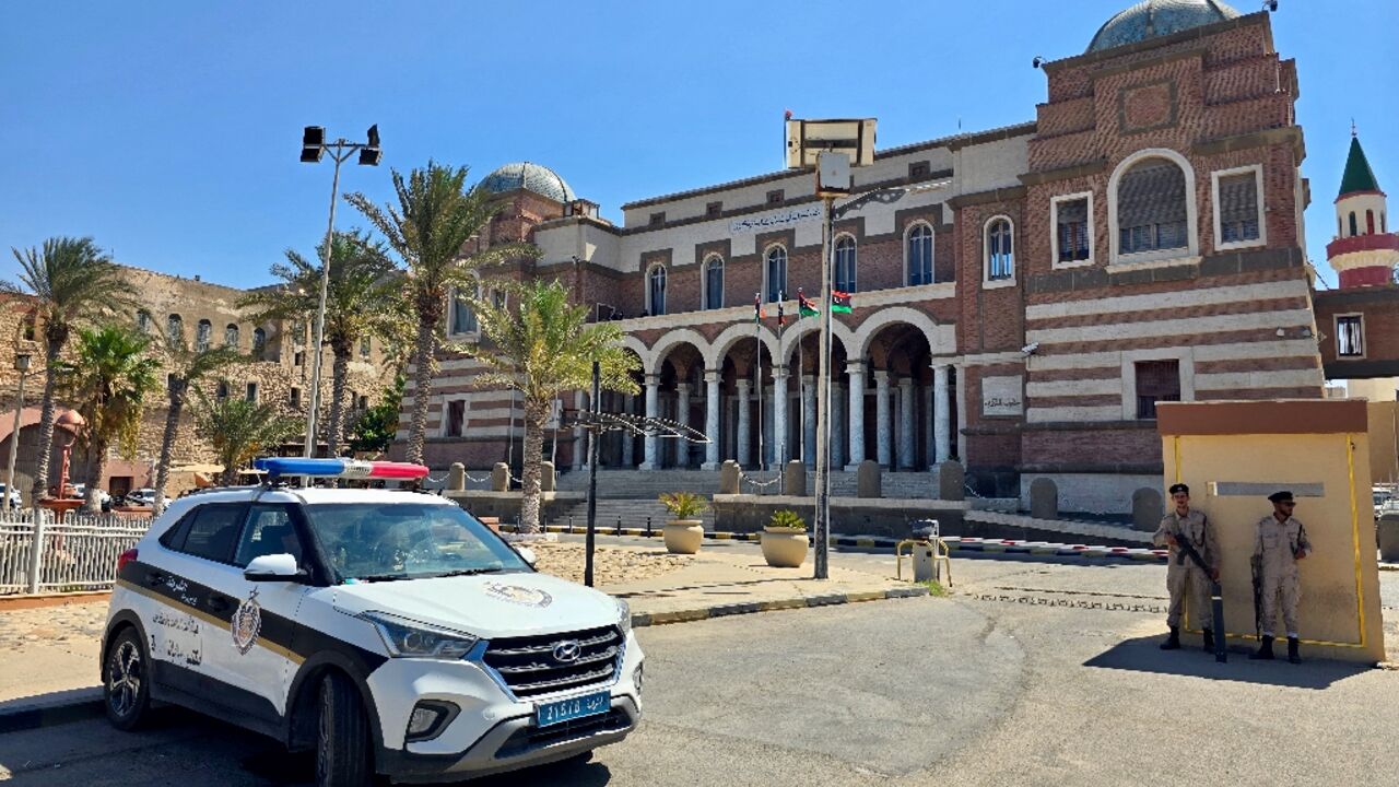 Police officers stand guard outside Libya's central bank headquarters in Tripoli