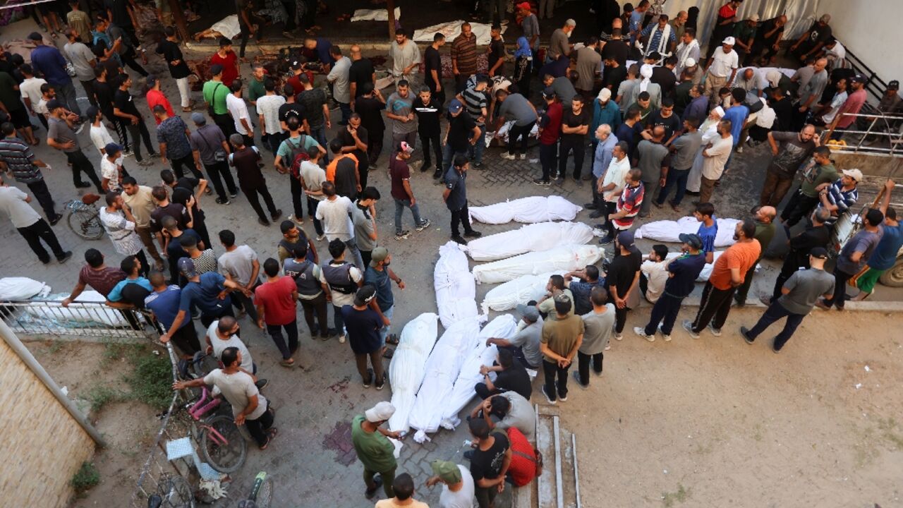 Shrouded bodies lie at a hospital after an Israeli strike that Gaza's civil defence agency said killed 93 people including women and children at a school sheltering war displaced