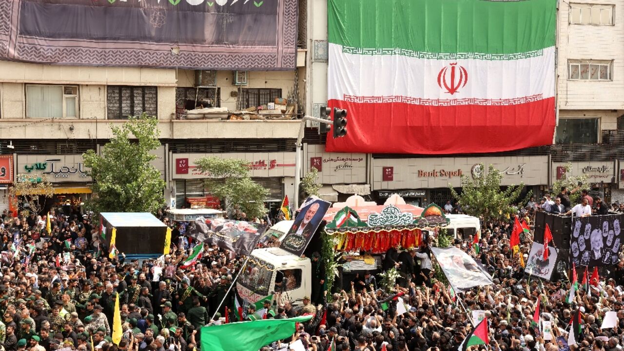 The caskets of Hamas political chief Ismail Haniyeh and his bodyguards were borne on a flower-bedecked truck