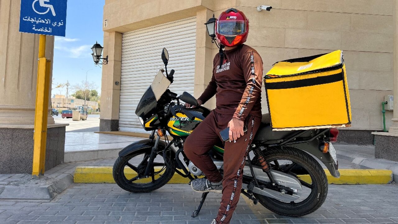 A Pakistani delivery worker poses for a photo during a break in the Saudi capital Riyadh 